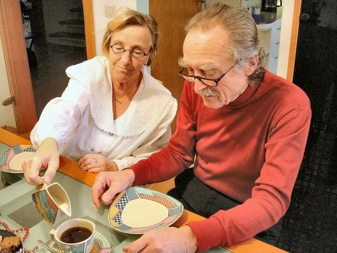 wife pouring coffee for husband wife pouring coffee for husband